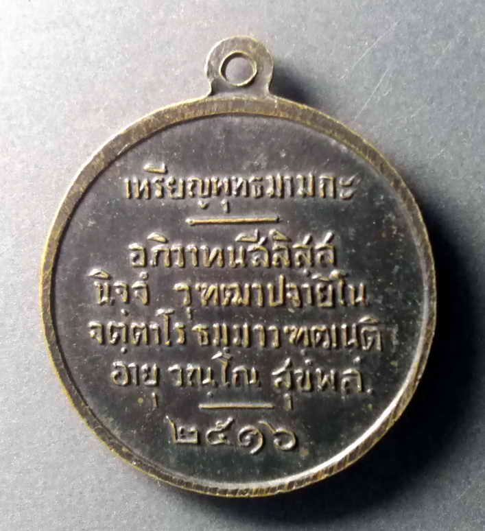 รหัสสินค้า เหรียญพระพุทธ 385 เหรียญพุทธมามกะ ด้านหลังเป็นภาษาบาลี อะภิวาทะนะสีลิสสะนิจจังวุฒาปะจายิโนจัตตาโรธัมมาวัฑฒันติอายุวัณโณสุขังพลัง สร้างปี 2516 เป็นคำอวยพร ของพระสงฆ์ซึ่งโดยส่วนใหญ่แล้วจะให้ตอนที่ประชาชนใส่บาตร พระรายการนี้ให้เช่าบูชาแล้ว
