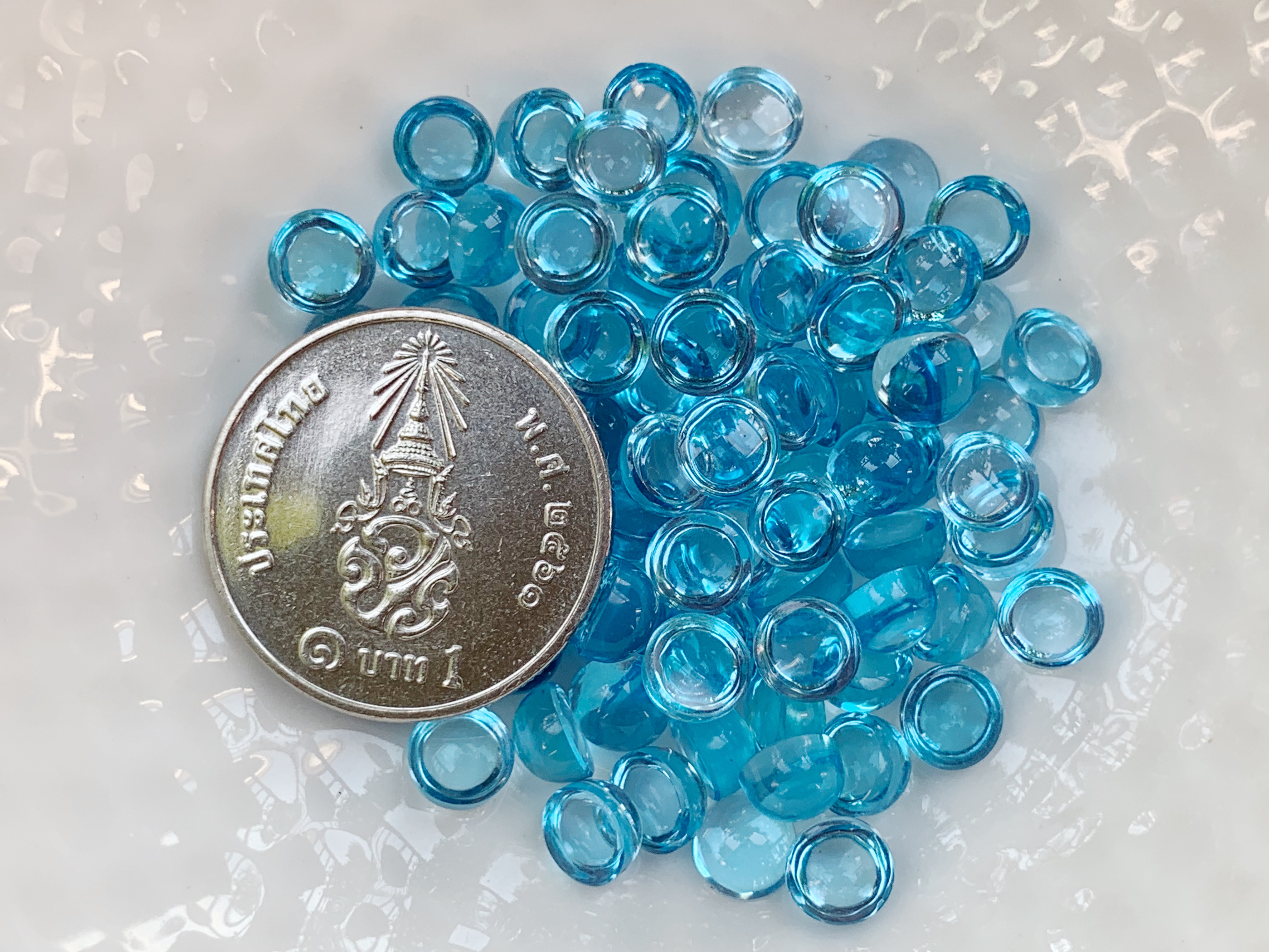 บลูโทปาสกลมหลังเบี้ย 5.0 มม. 5 กะรัต